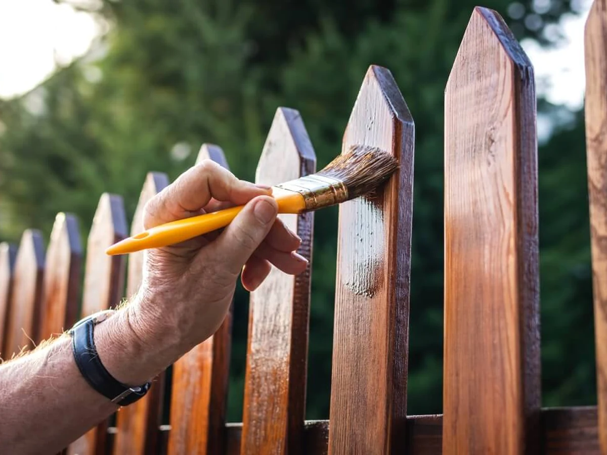 Painting a wooden picket fence in Altrincham