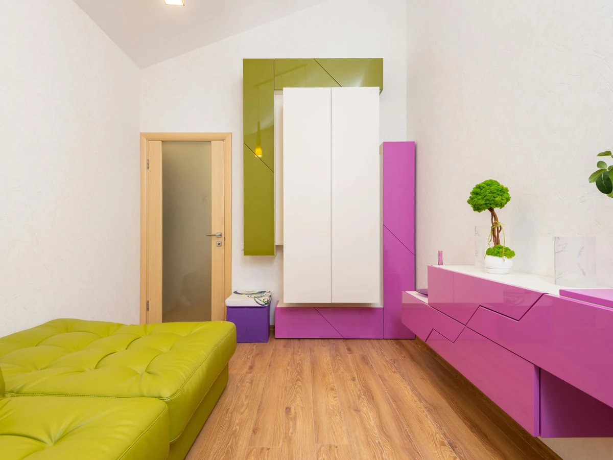 Bright room with green accent wall prepared for wallpapering