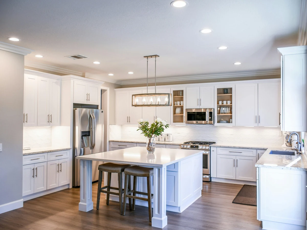 White kitchen with island unit and professionally painted cabinets