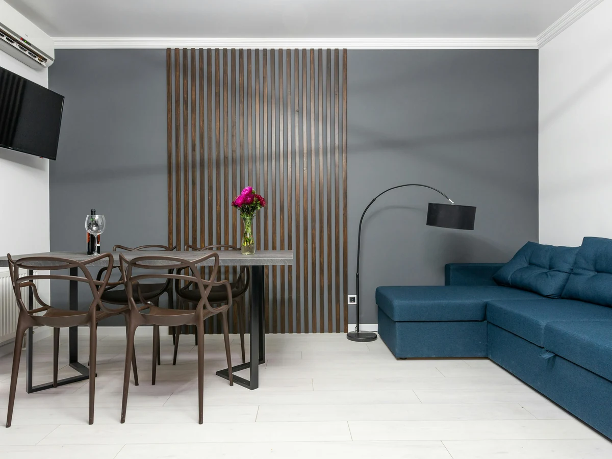 Compact lounge with teal feature wall painted by Altrincham Decorators