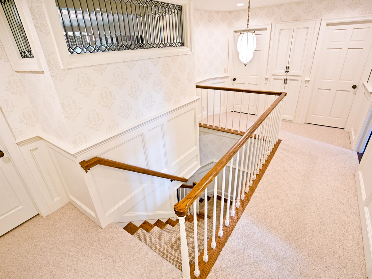 Elegant white banister staircase painting in Altrincham by Altrincham Decorators