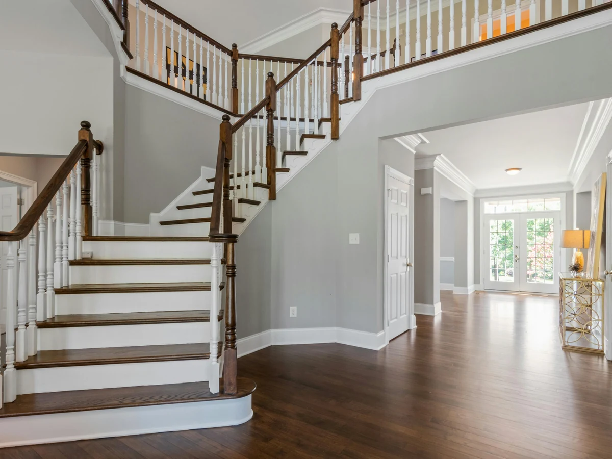 Staircase painting in Altrincham - grand curved staircase painted by Altrincham Decorators