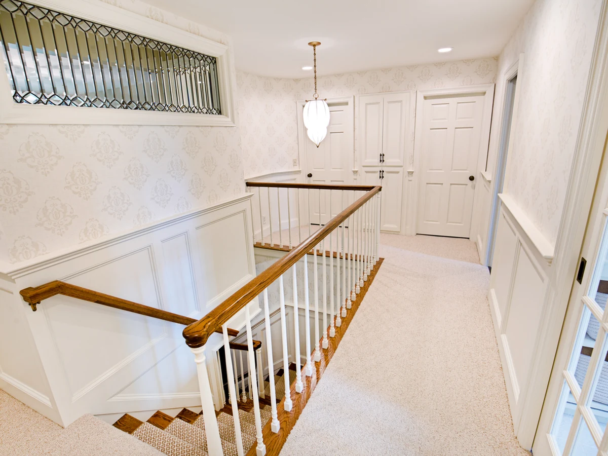 Staircase painting in Hale, residential stairwell white finish by Altrincham Decorators